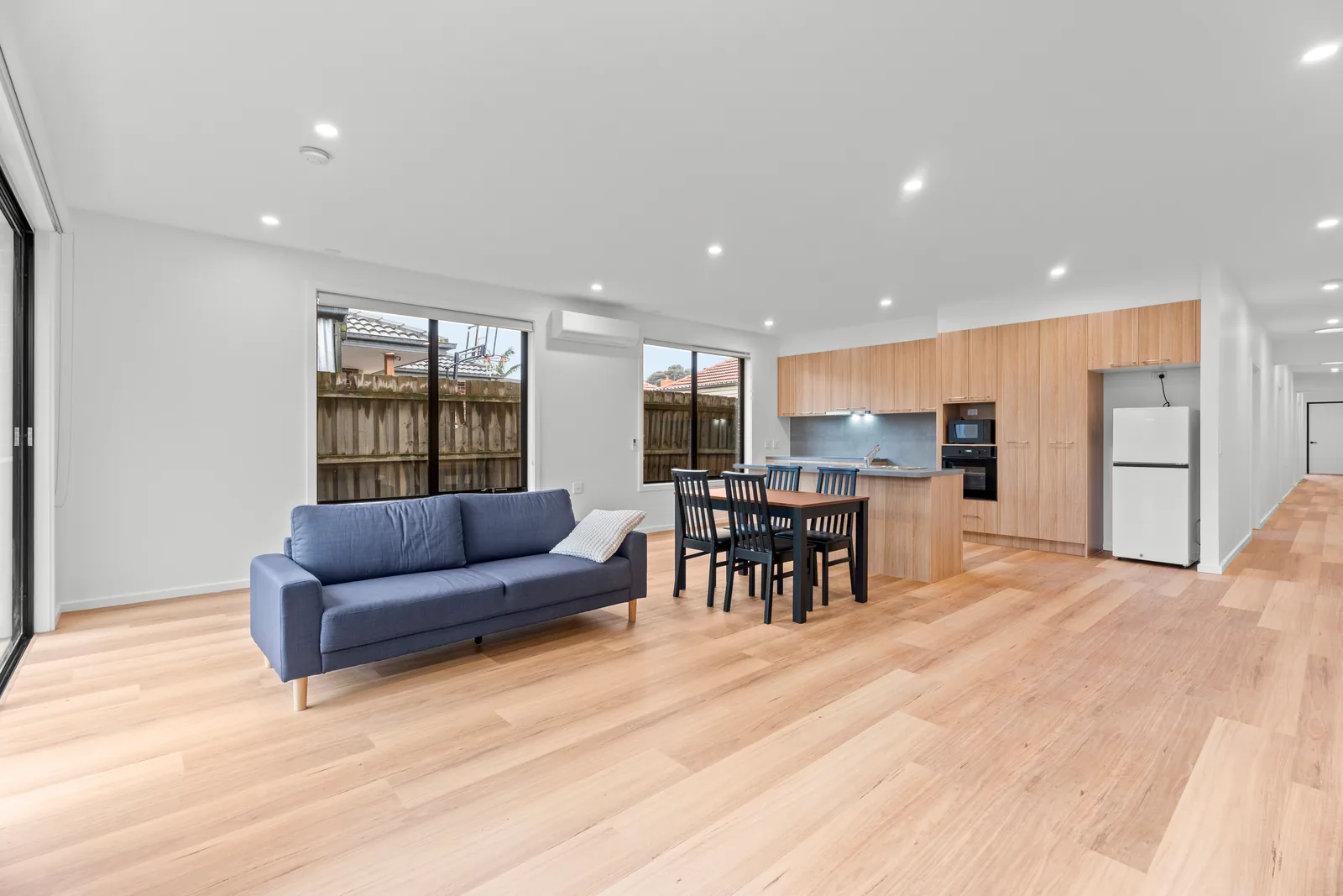 Open living area with a sofa and dining table