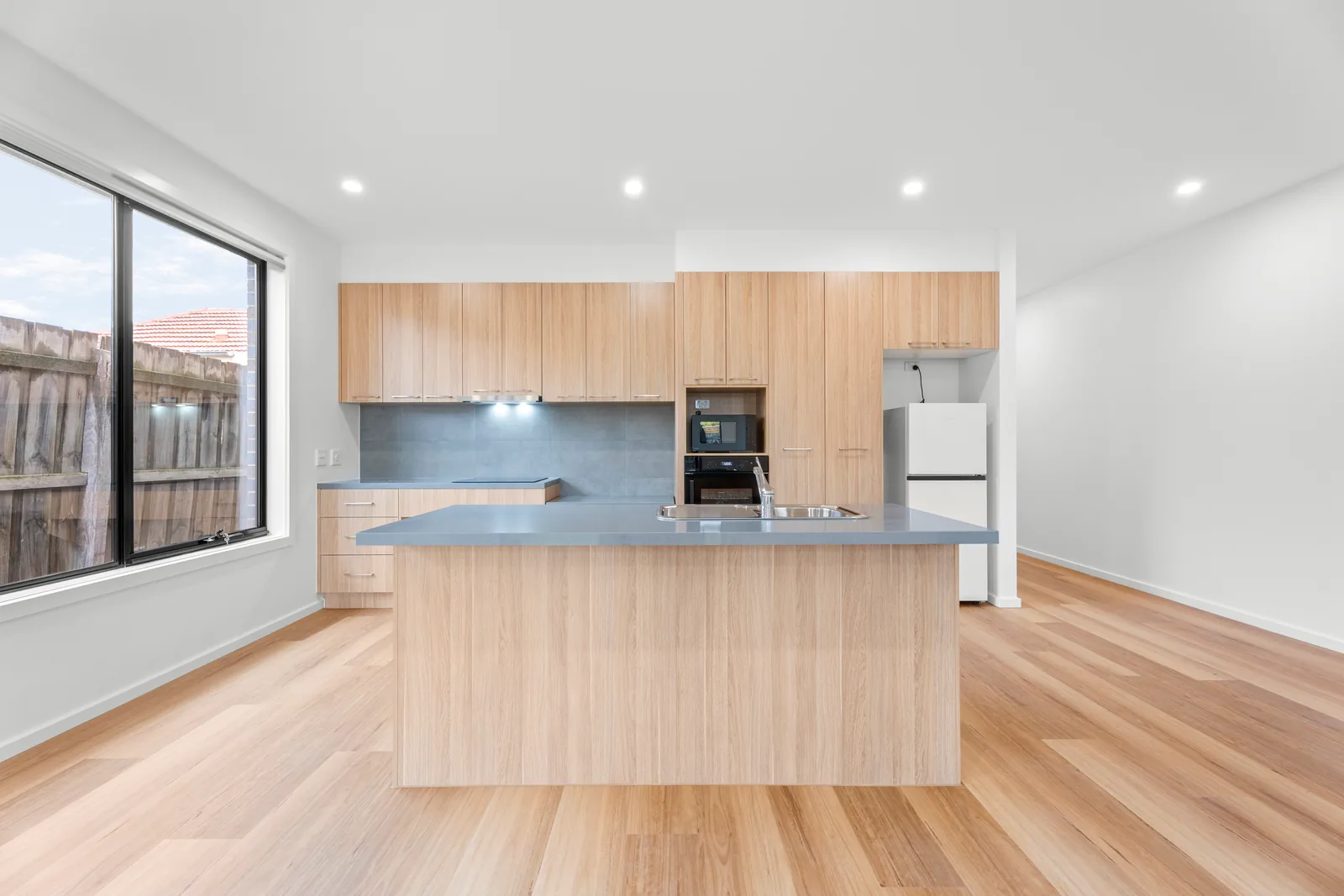 Kitchen with an island bench and wall ovens