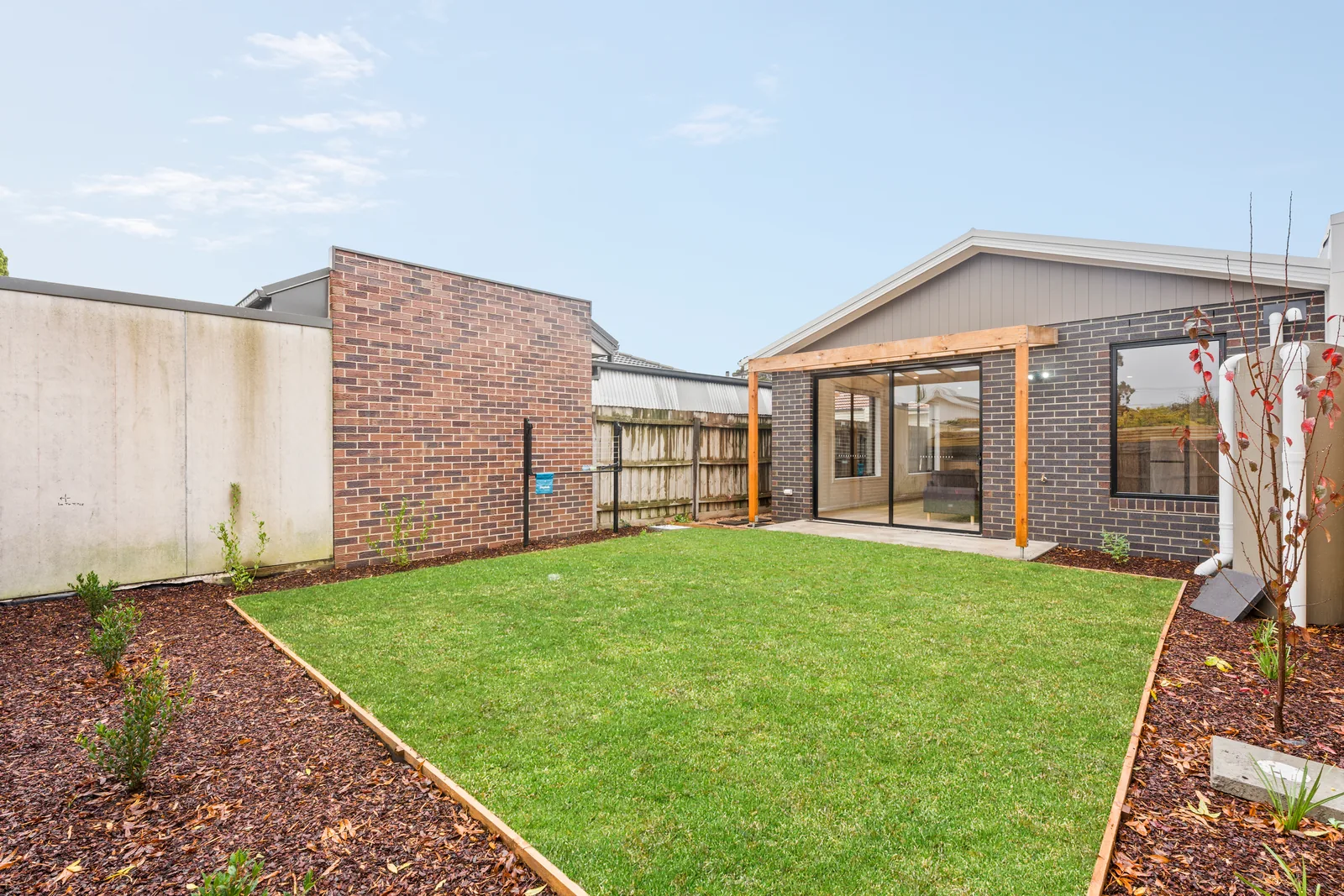 Enclosed back garden with lawn