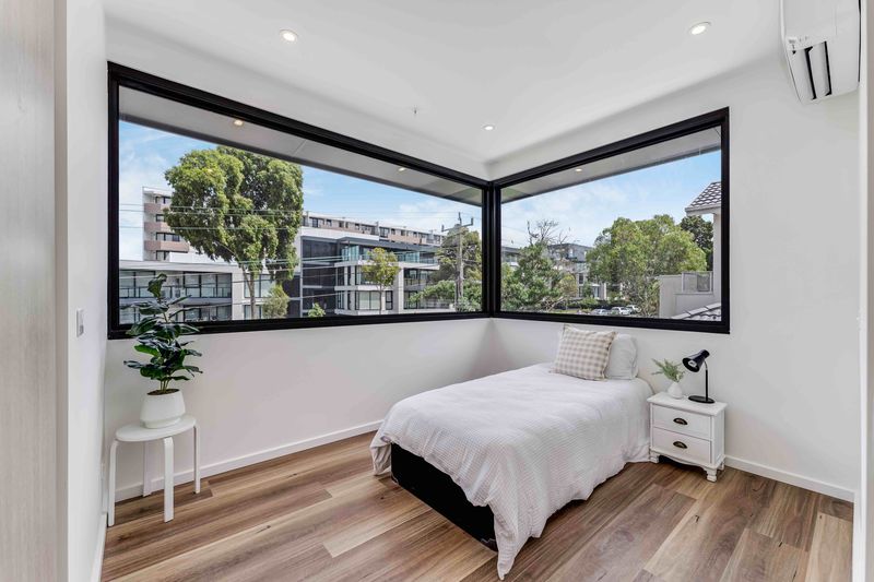 Bedroom with large corner window