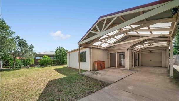 Fenced backyard with covered pergola area
