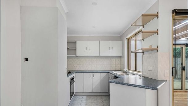 Kitchen with white cabinetry and gas cooktop