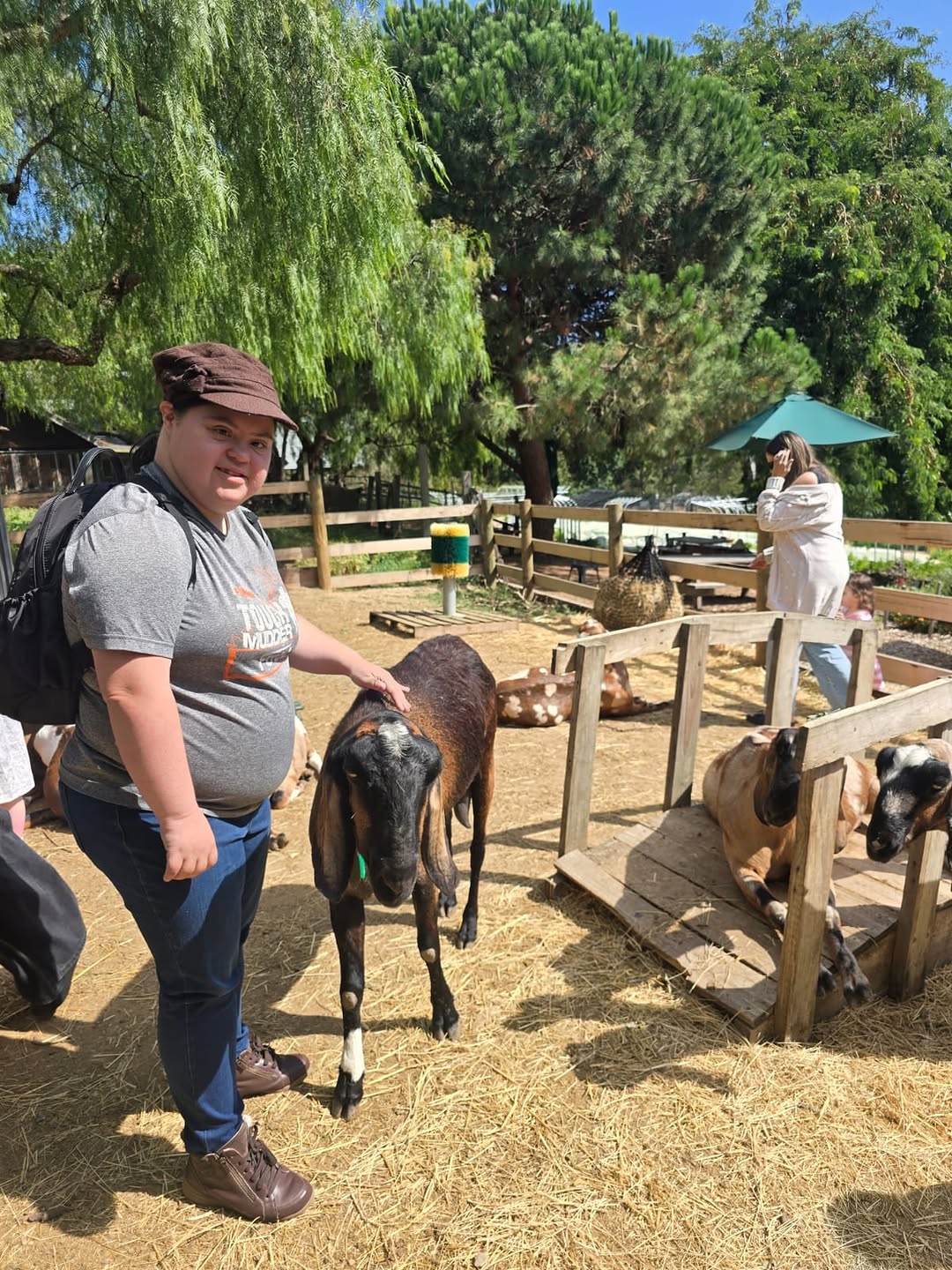 A participant feeding goats on a farm visit