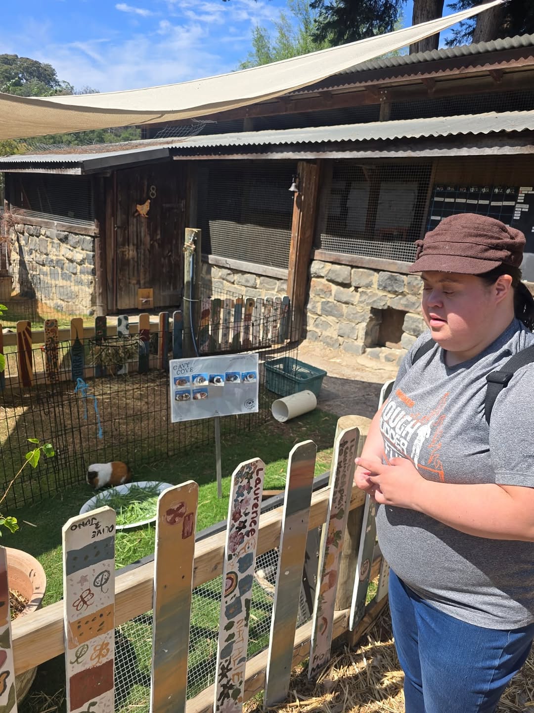A participant enjoying a day out at a farm with support
