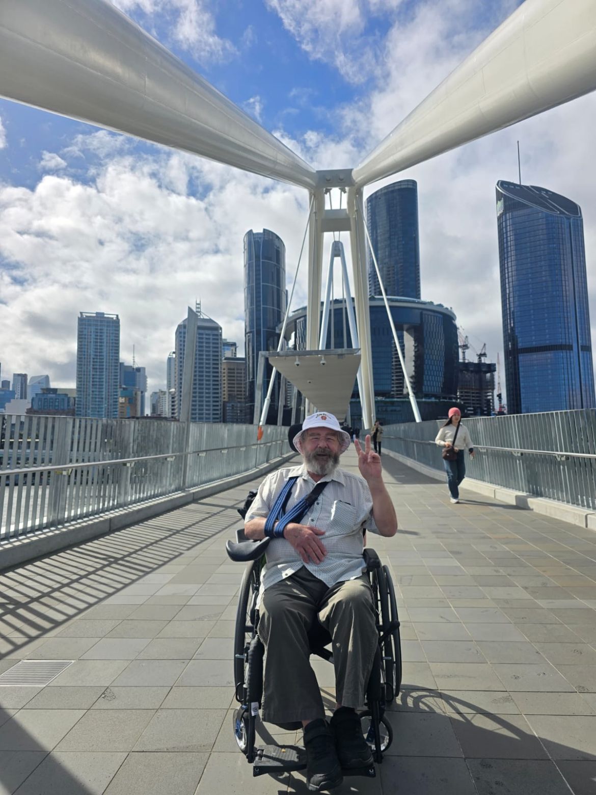 A participant crossing a city bridge during a community outing