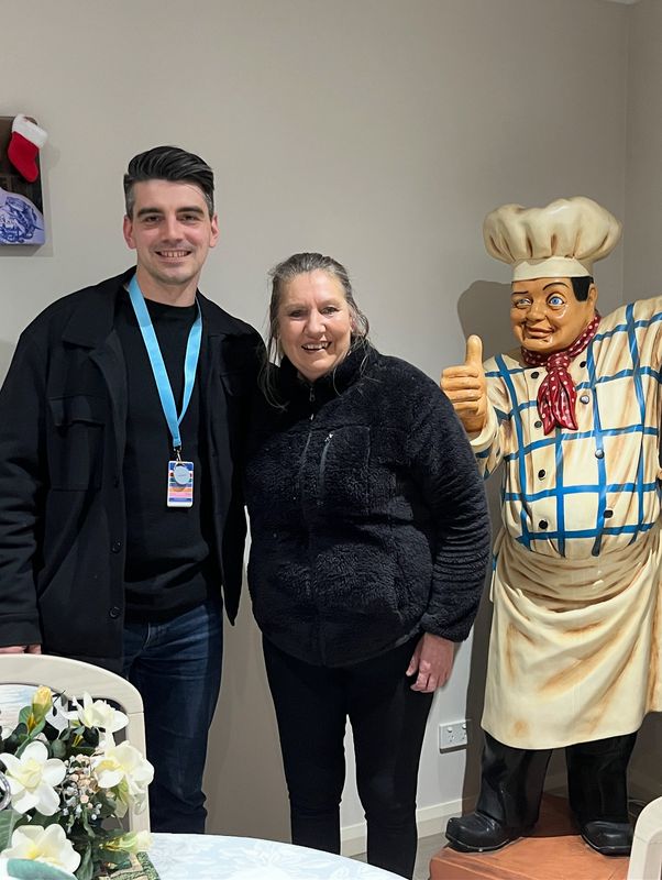 A support worker and participant together during a community outing