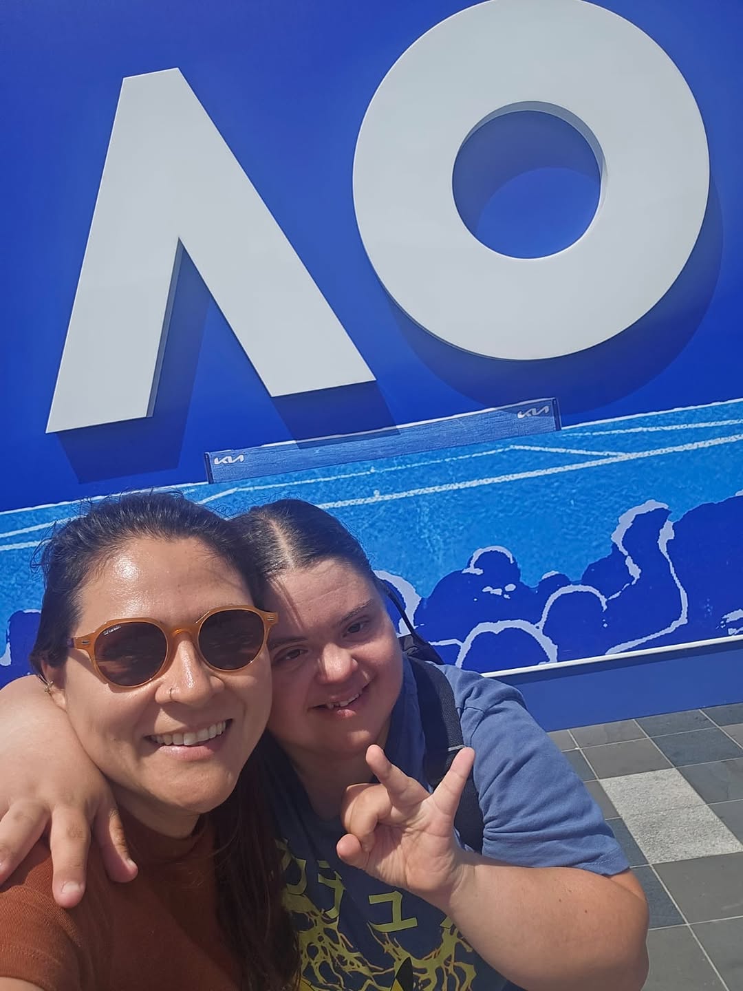 A support worker and participant taking a selfie at tennis