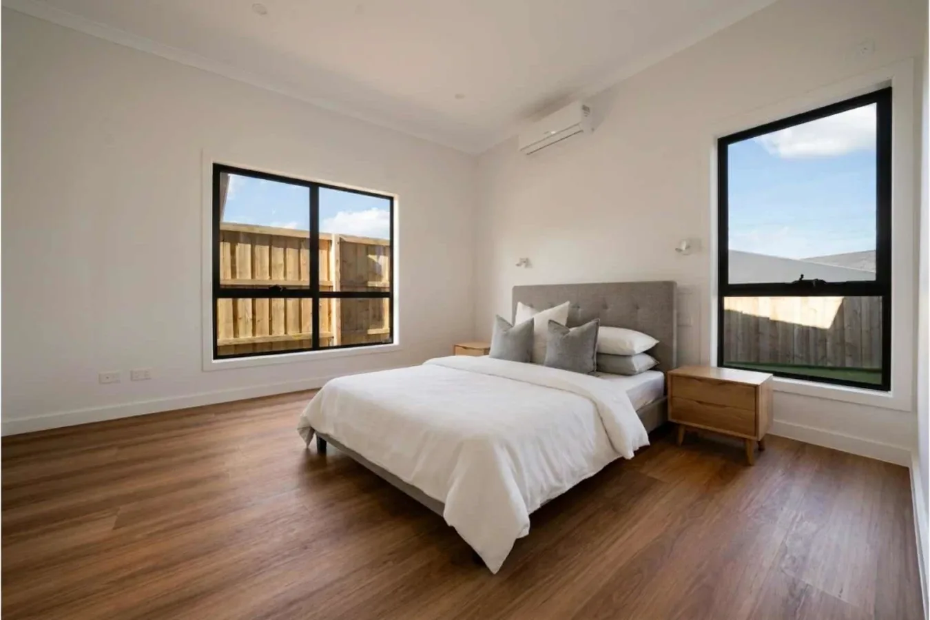 Bedroom with windows on two walls and space to move around the bed